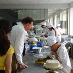 Dr Tempest-Mogg looks on as students work on their icing